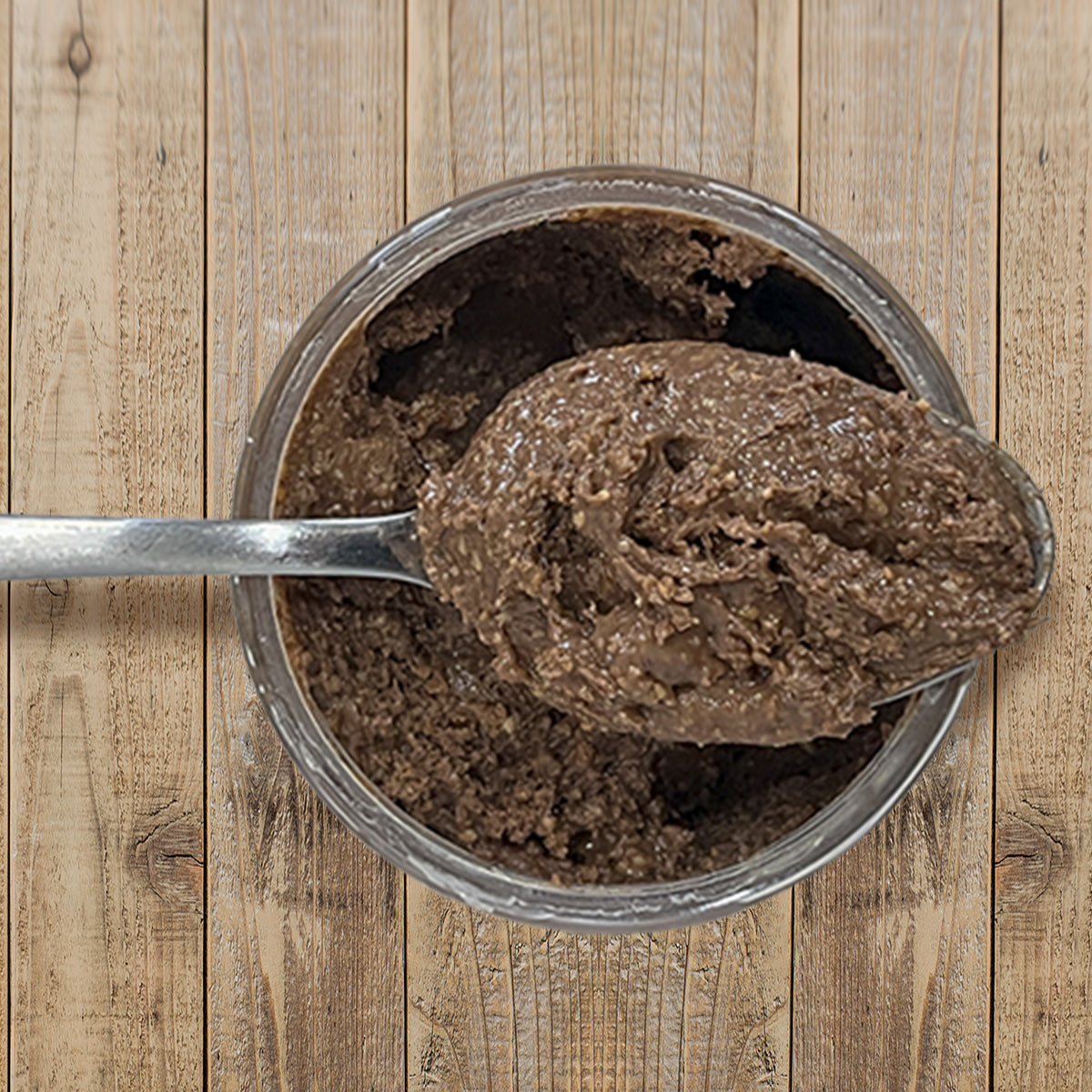 Dark Chocolate Almond Butter top view of open container with spoon full of peanut butter