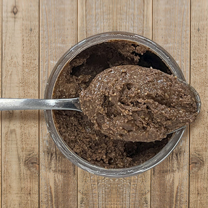 Dark Chocolate Almond Butter top view of open container with spoon full of peanut butter